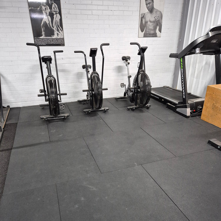 Gymsport 1m x 1m black commercial rubber gym flooring tile with non-slip texture.