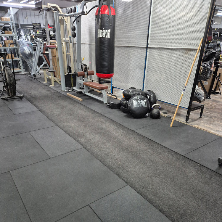 Durable 1m x 1m Gymsport rubber mats in a high-impact commercial fitness training space.