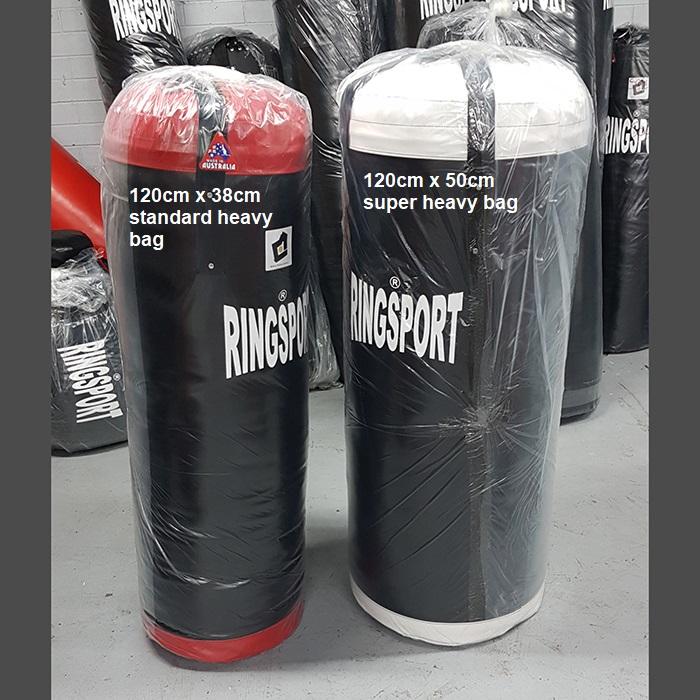 Two punching bags by RINGSPORT, one labeled as '120cm x 38cm standard heavy bag' and the other as '120cm x 50cm super heavy bag'.